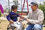 56944-thomas-bob-stirling-sharing-jerky-with-ecuador-child.jpg