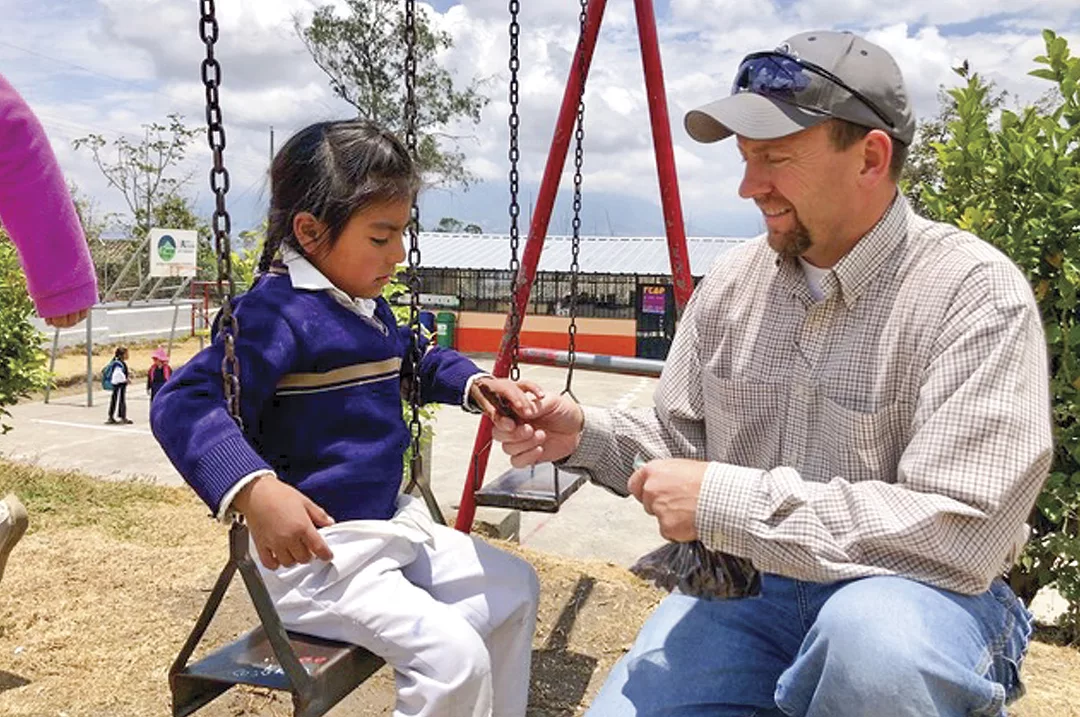 56944-thomas-bob-stirling-sharing-jerky-with-ecuador-child.jpg