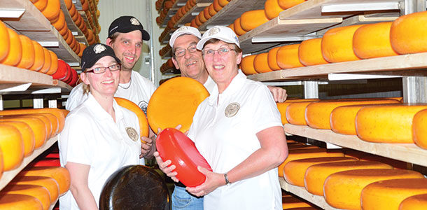 Baukje, Arjo, Adam and Hannie van Bergeijk hold some of the colourful cheese wheels