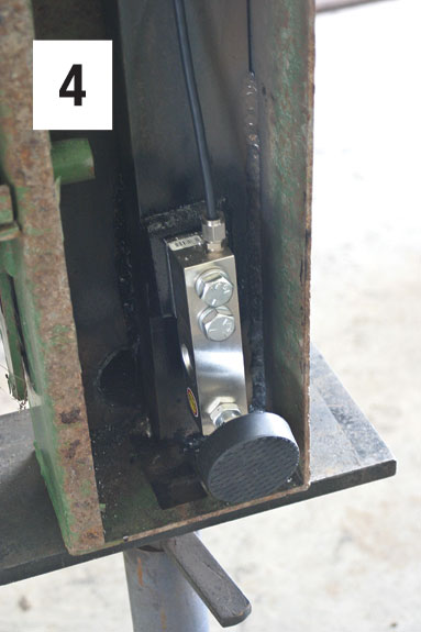 A load sensor attached to the bottom of a squeeze chute