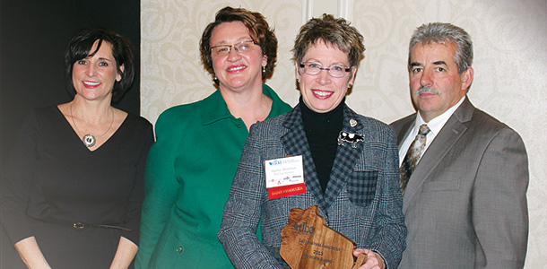 Daphe Holterman receiving Dairy Business Assocation Advocate Award