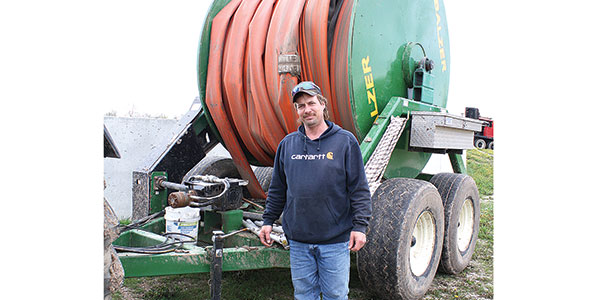 Dave Eisentraut by a hose
