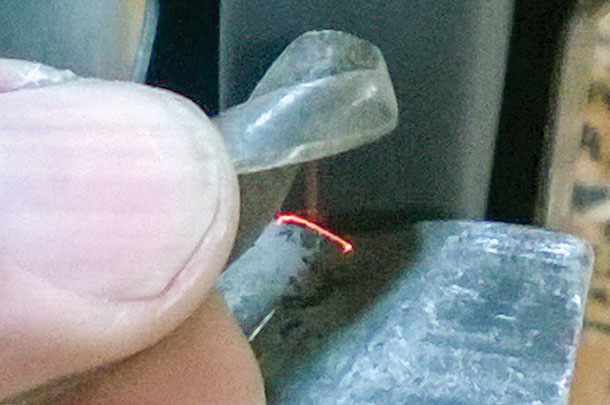 Use your finger as a fulcrum on which to roll the bit as your move it against the grandstone