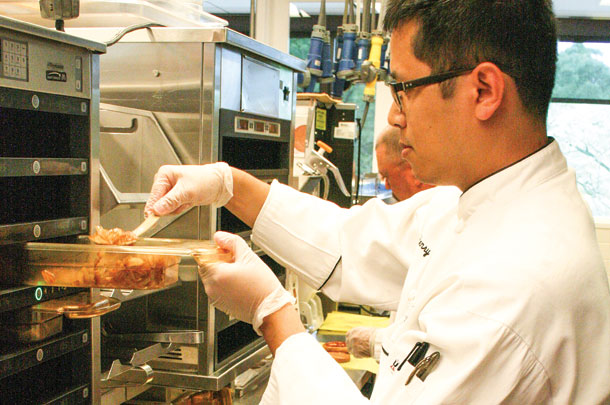 A chef prepares a new specialty burger
