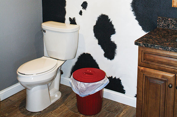 Even the bathroom is decked out in dairy detail with a cow-spotted wall.