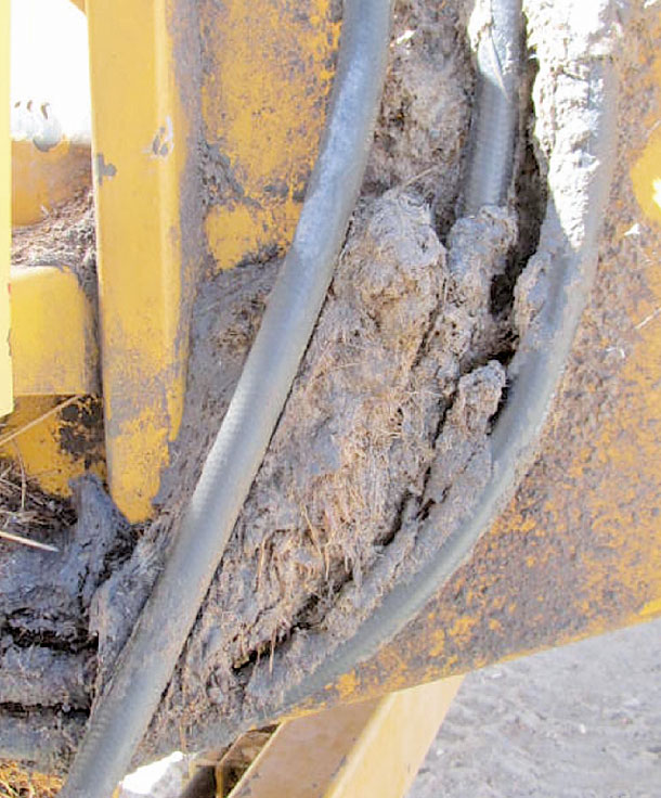 Hay chaff has collected around a hydraulic oil leak