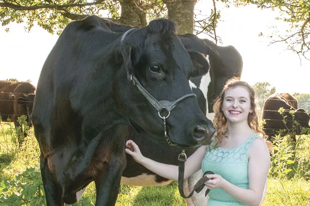 Riley DuBois with pet cow Puppy