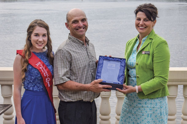 National Red and White Queen Present doug Lyons with Master Breeder Award