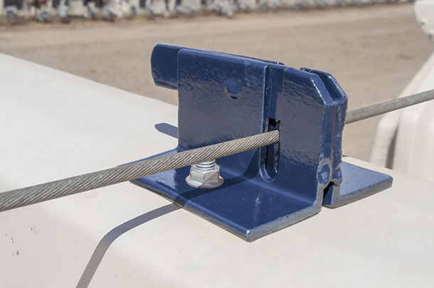 New latch for calf hutches attaches to a tethered cable and helps secure hutches against high winds