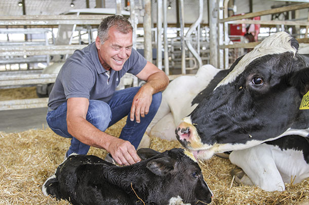 CEO Ro Kreider with a newborn calf