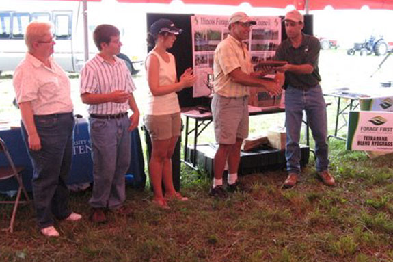 Dave Surprenant and his family accept a certificate of appreciation