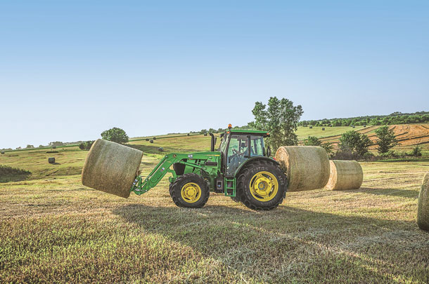John Deere 6E tractor in field