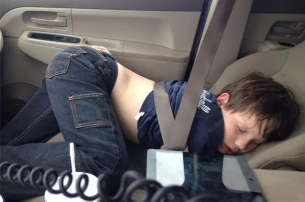 Boy sleeping in car