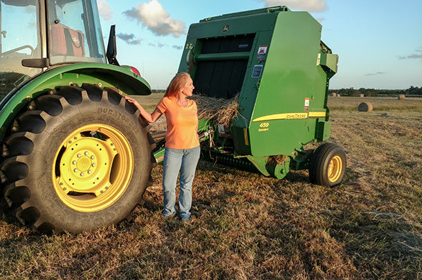 Janet Guidry and hay baler