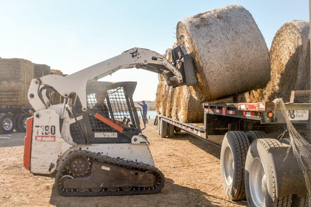 unloading hay bales