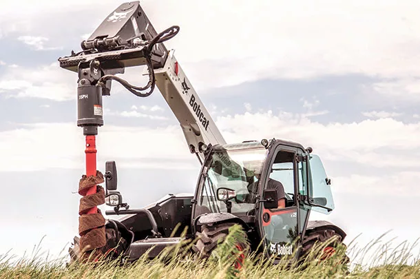 Bobcat V519 telescopic tool carrier with post-hole auger