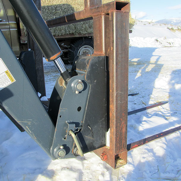 Quick-tach mounting brackets on this four-spear, hay loader