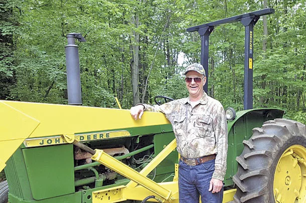A John deere model 2010 tractor with a rollover protection structure