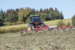 Using a tedder to help with drydown on late-season grass hay.