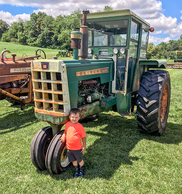 My son, Griffin, at our 2018 show proudly standing by his dad's 1964 Oliver 1800-C with Full View cab