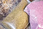 Coated and uncoated alfalfa seeds